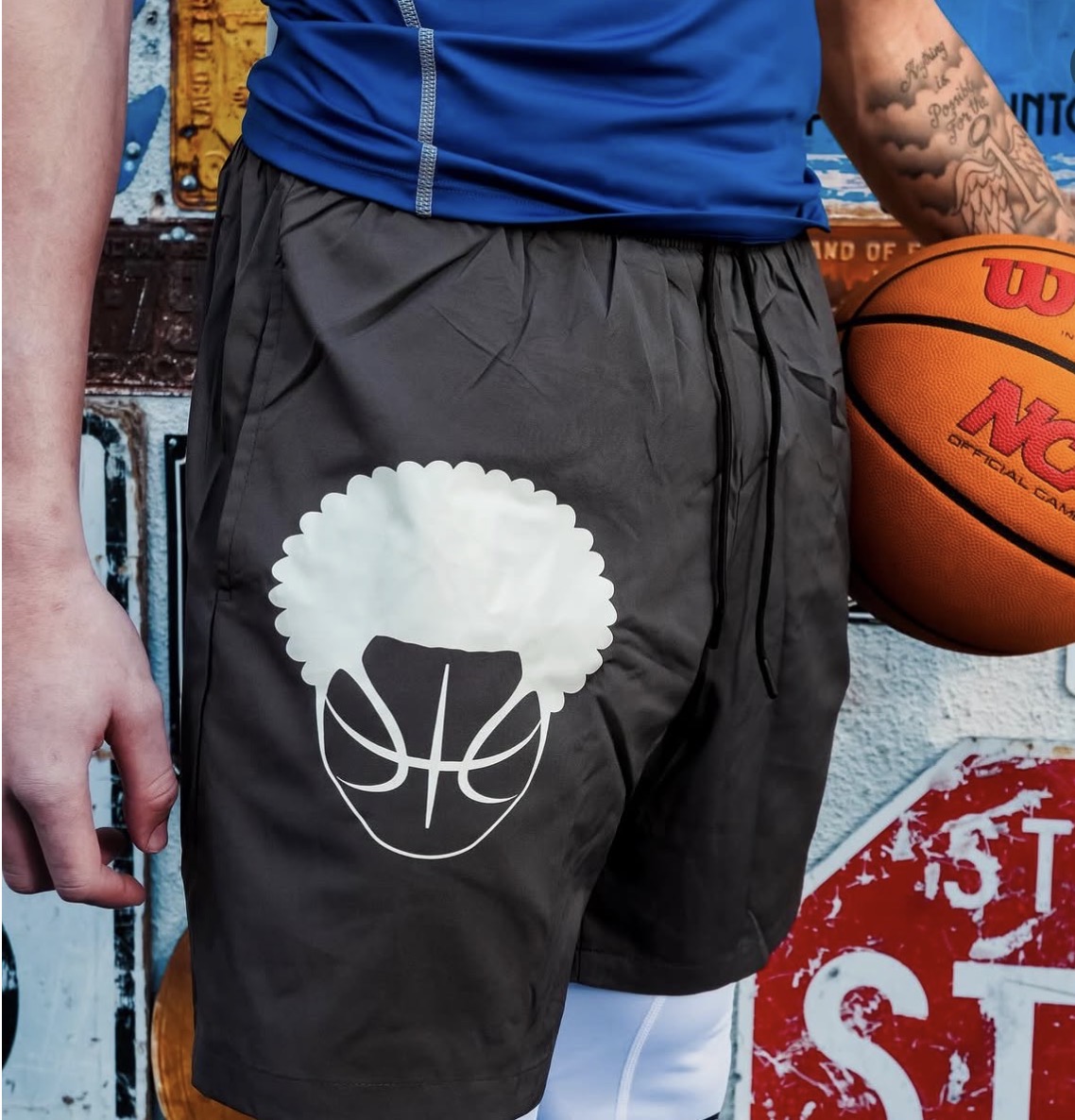 Black Ball Head Hoops athletic shorts with large afro basketball logo on the thigh